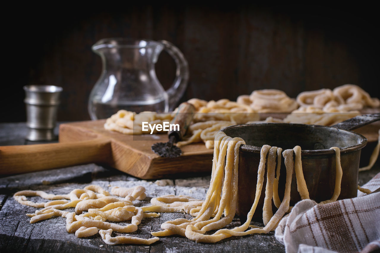 Close-up of dough with utensils on table