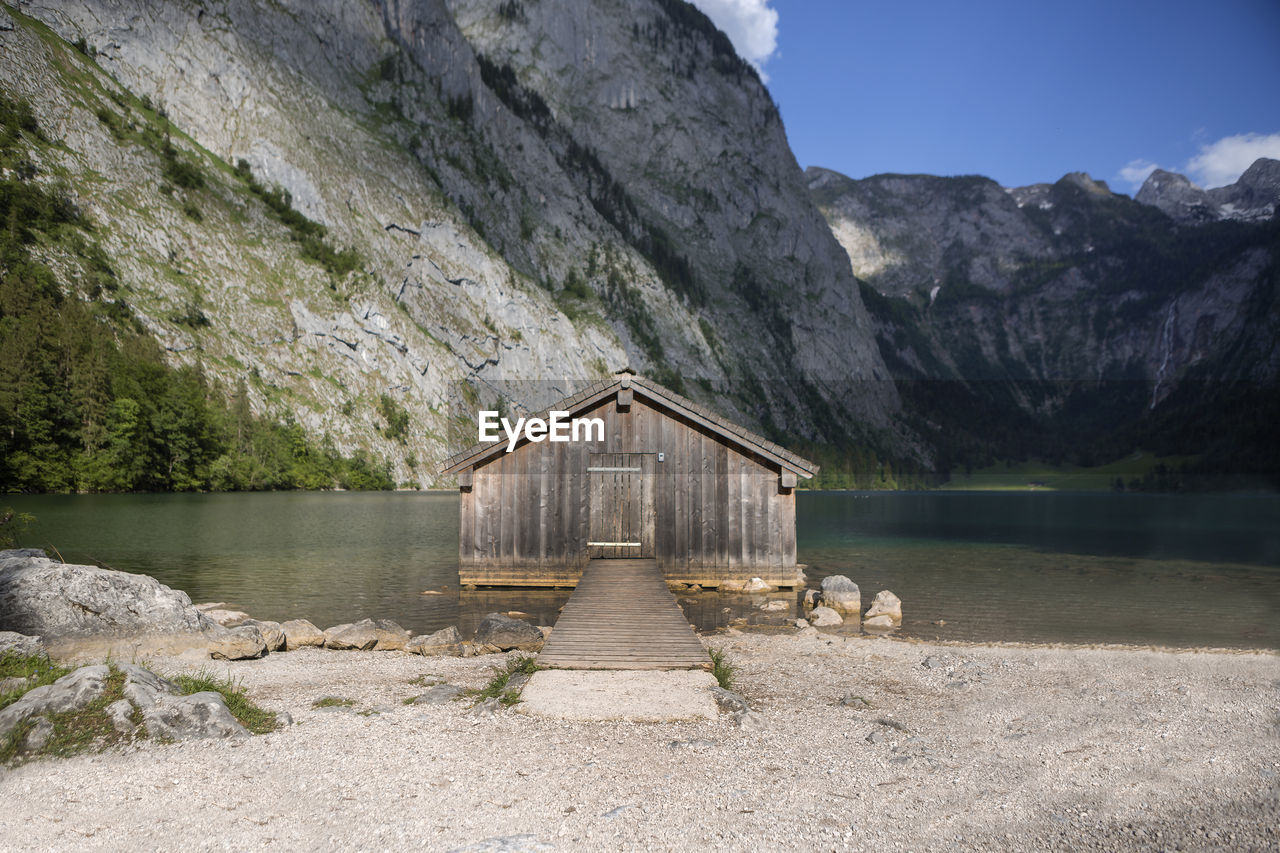 built structure by lake against mountain