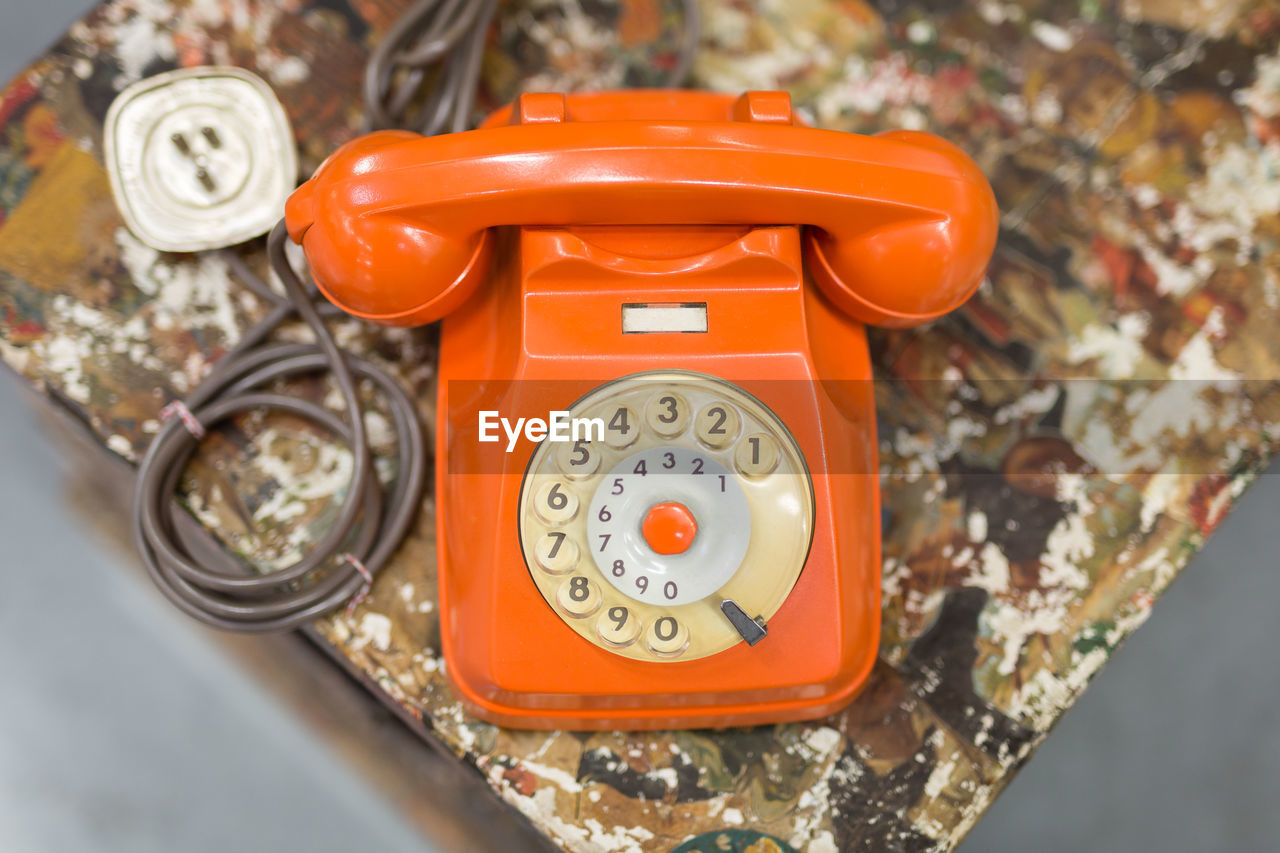 Antique vintage analog orange phone, communication concept theme.