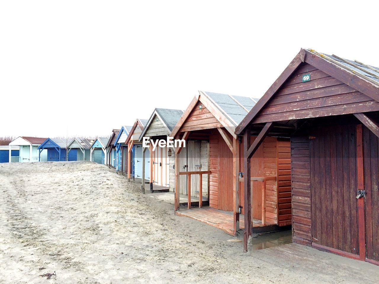 Beach huts against clear sky