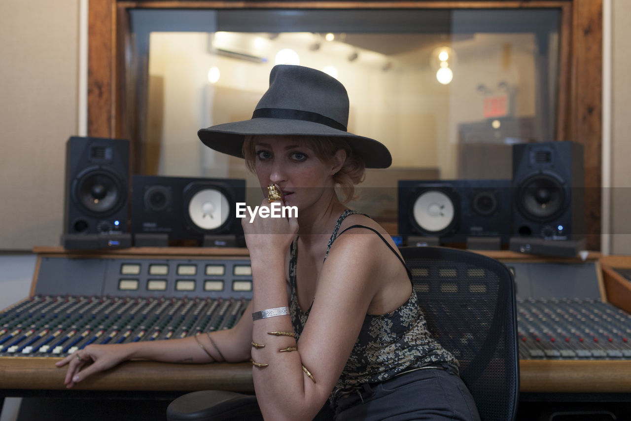 Portrait of a young woman in a recording studio