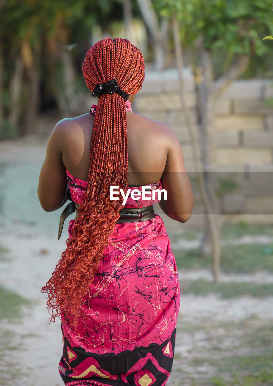 African woman dressed in traditional clothes walks through the village of keta ghana west africa