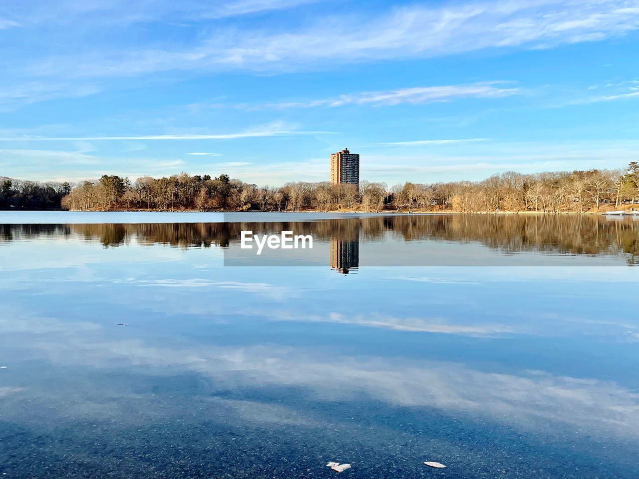 reflection, water, sky, lake, horizon, nature, morning, reservoir, shore, architecture, scenics - nature, blue, tranquility, no people, cloud, beauty in nature, body of water, built structure, landscape, tree, travel destinations, tranquil scene, day, plant, dusk, environment, outdoors, winter, building exterior, sunlight, building, travel