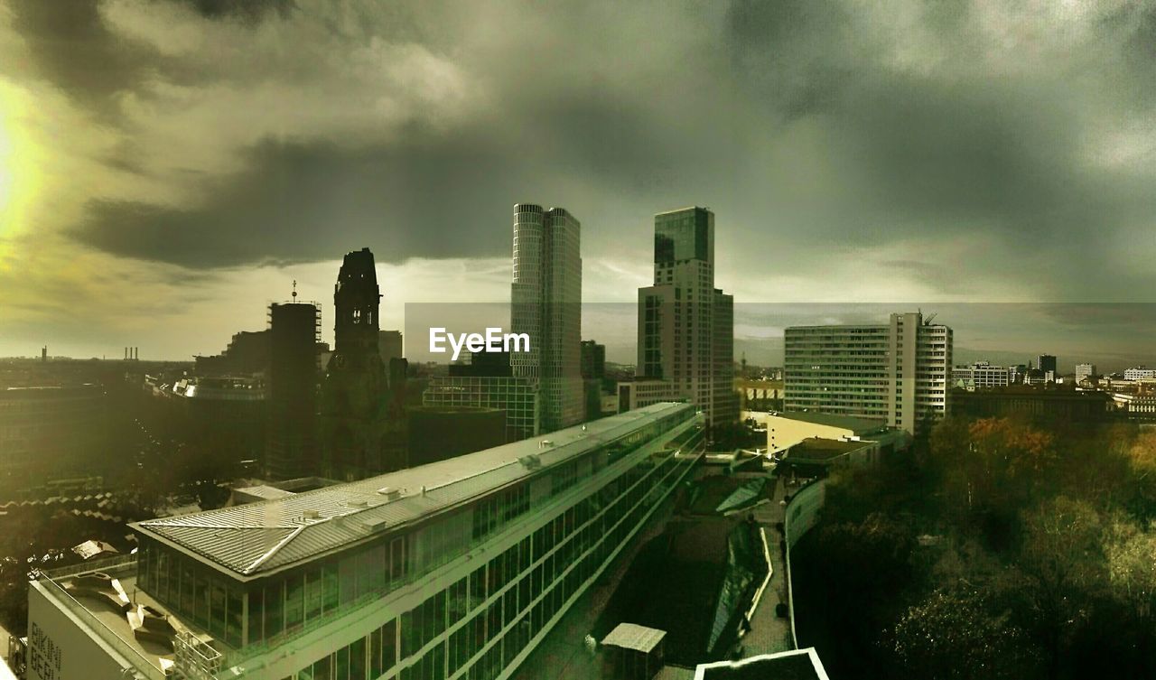 AERIAL VIEW OF ILLUMINATED CITY AGAINST SKY