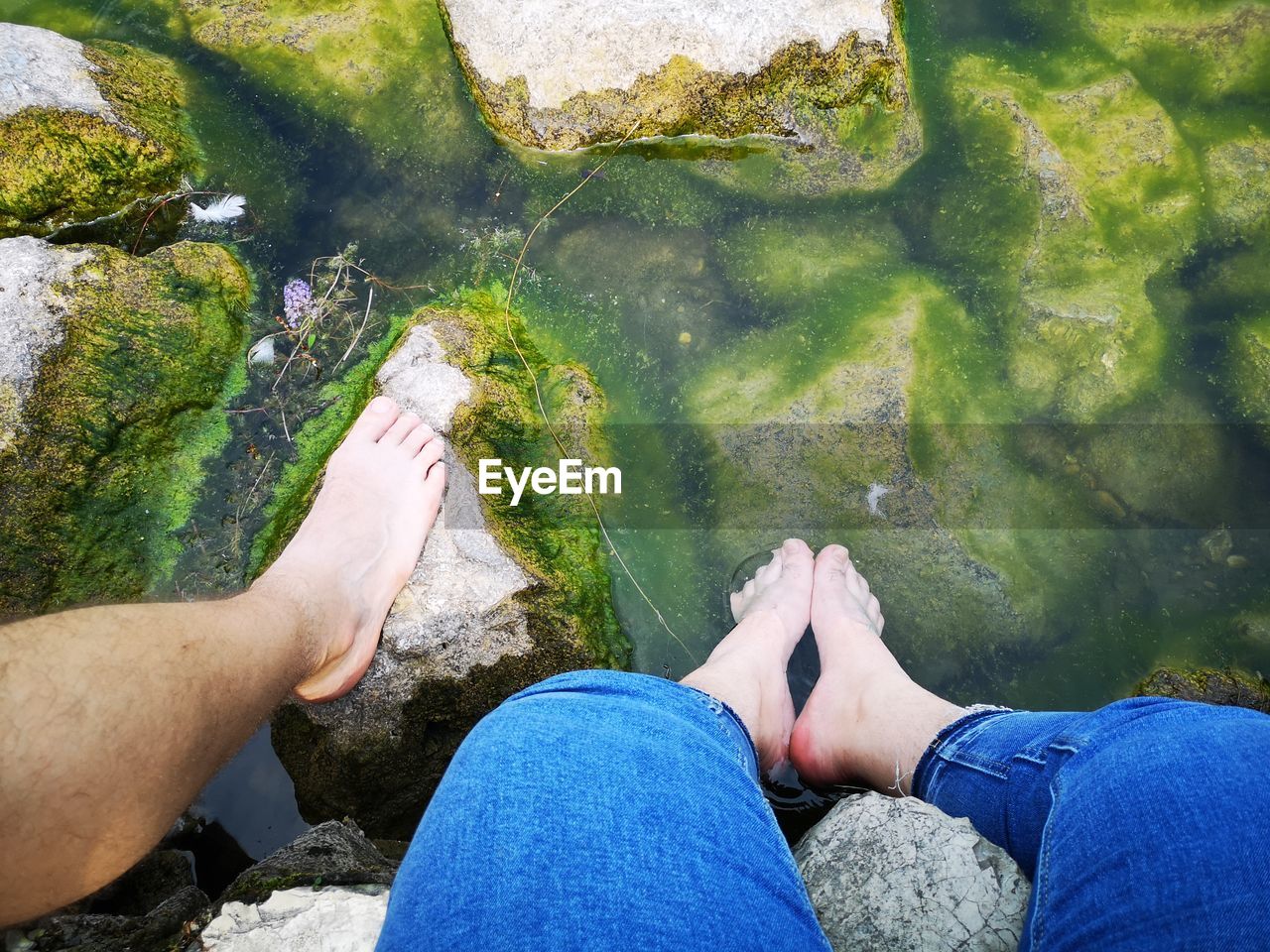 Low section of couple on rocks