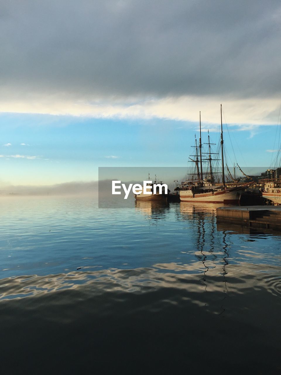 Ship moored on sea against sky