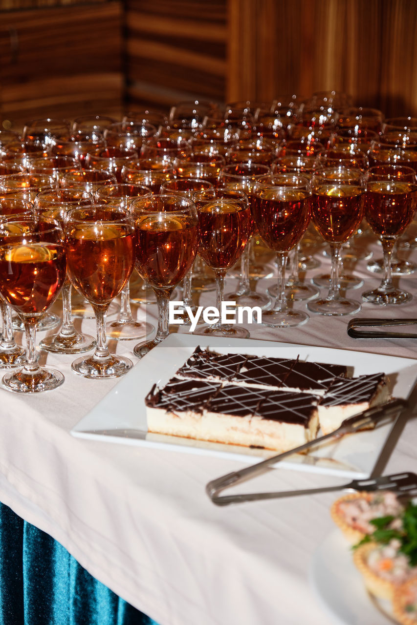 Close-up of wine glasses and food on table in restaurant