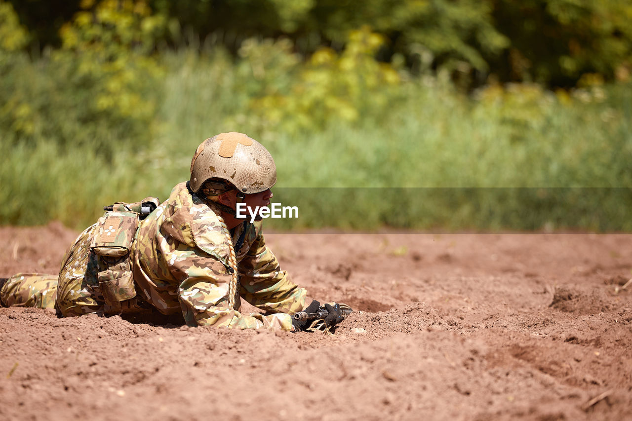 rear view of man standing on dirt