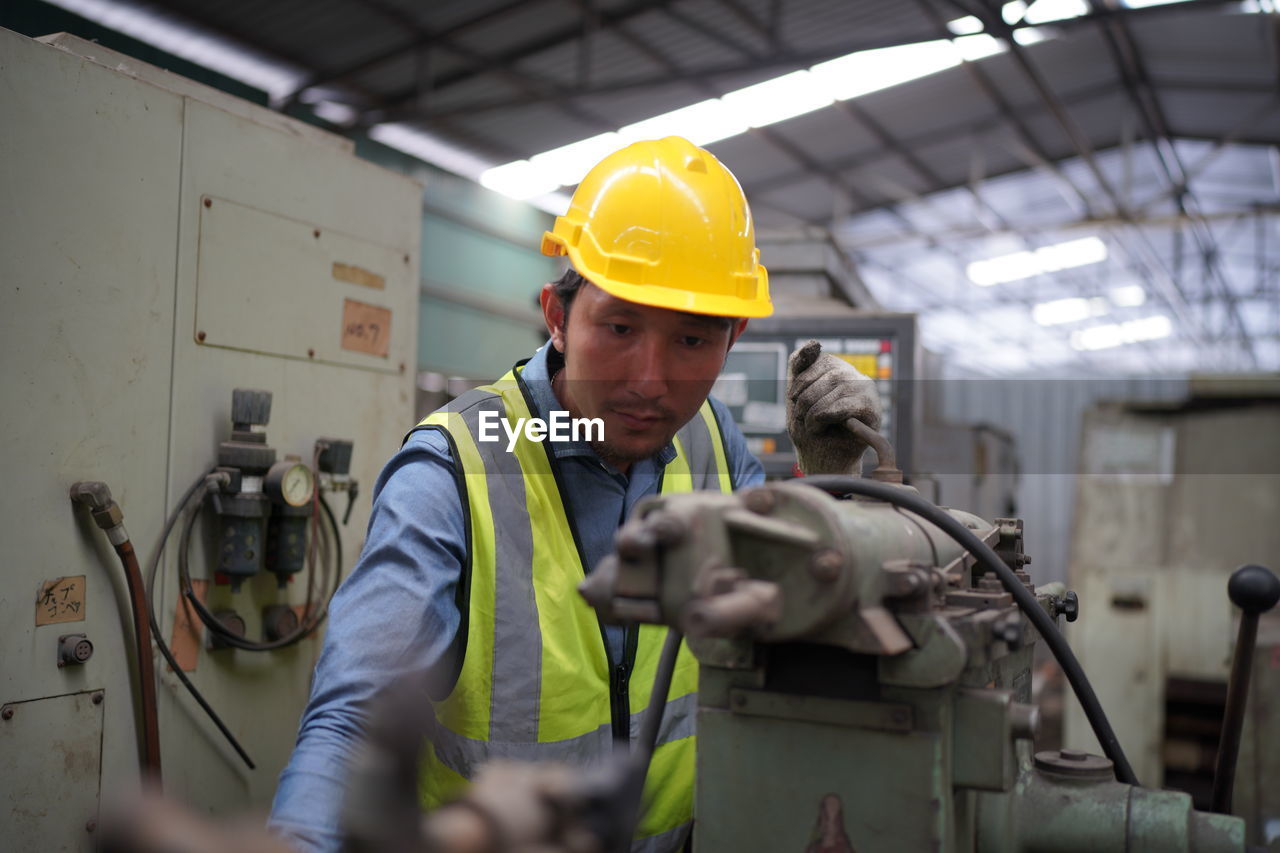 rear view of man working at factory