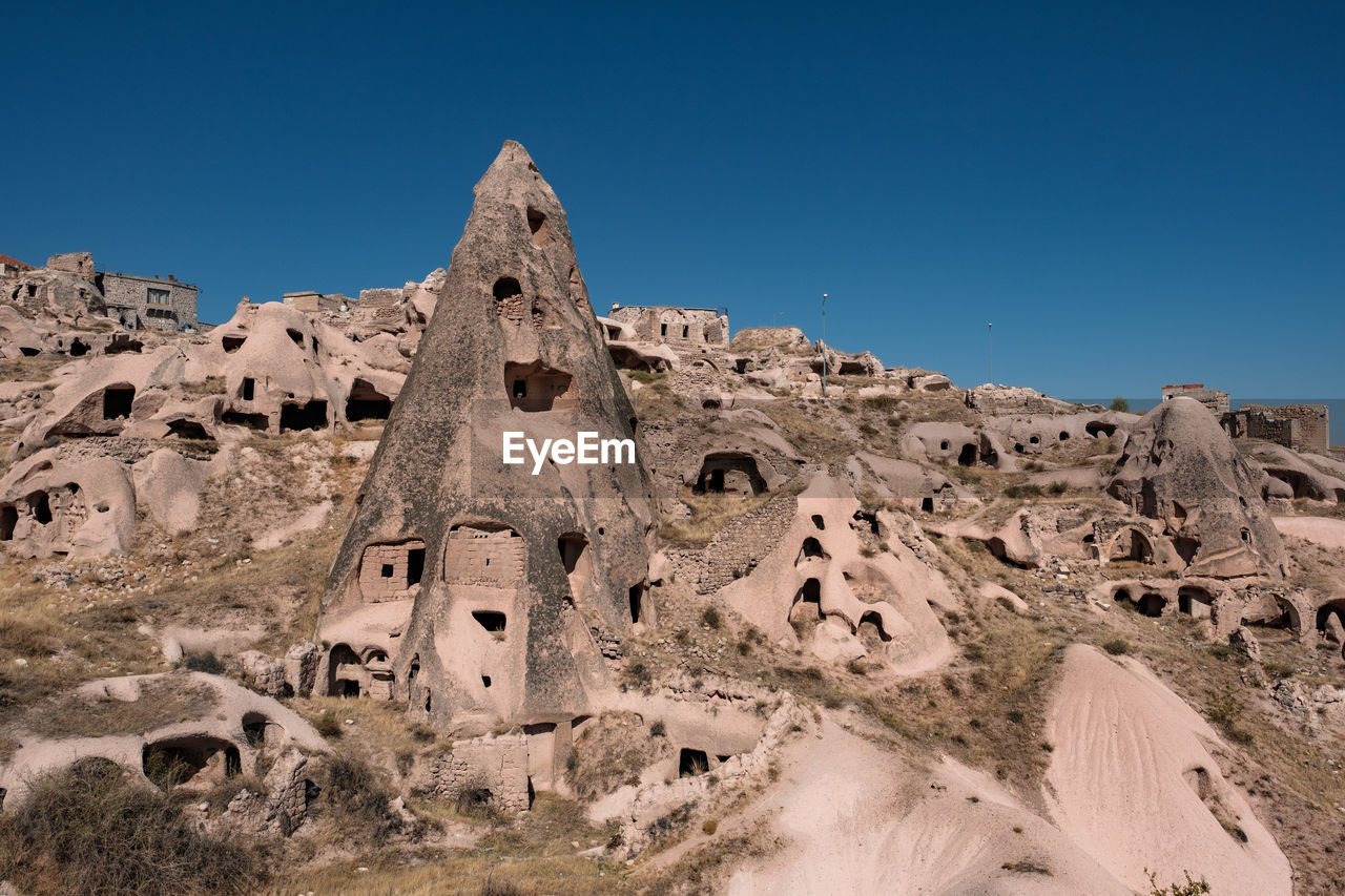 LOW ANGLE VIEW OF CASTLE ON LANDSCAPE AGAINST CLEAR BLUE SKY