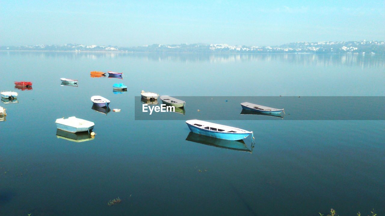 High angle view of boats moored at lake against sky