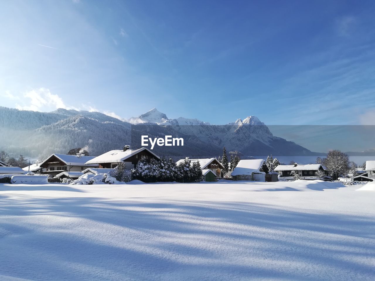 Scenic view of snowcapped mountains against blue sky