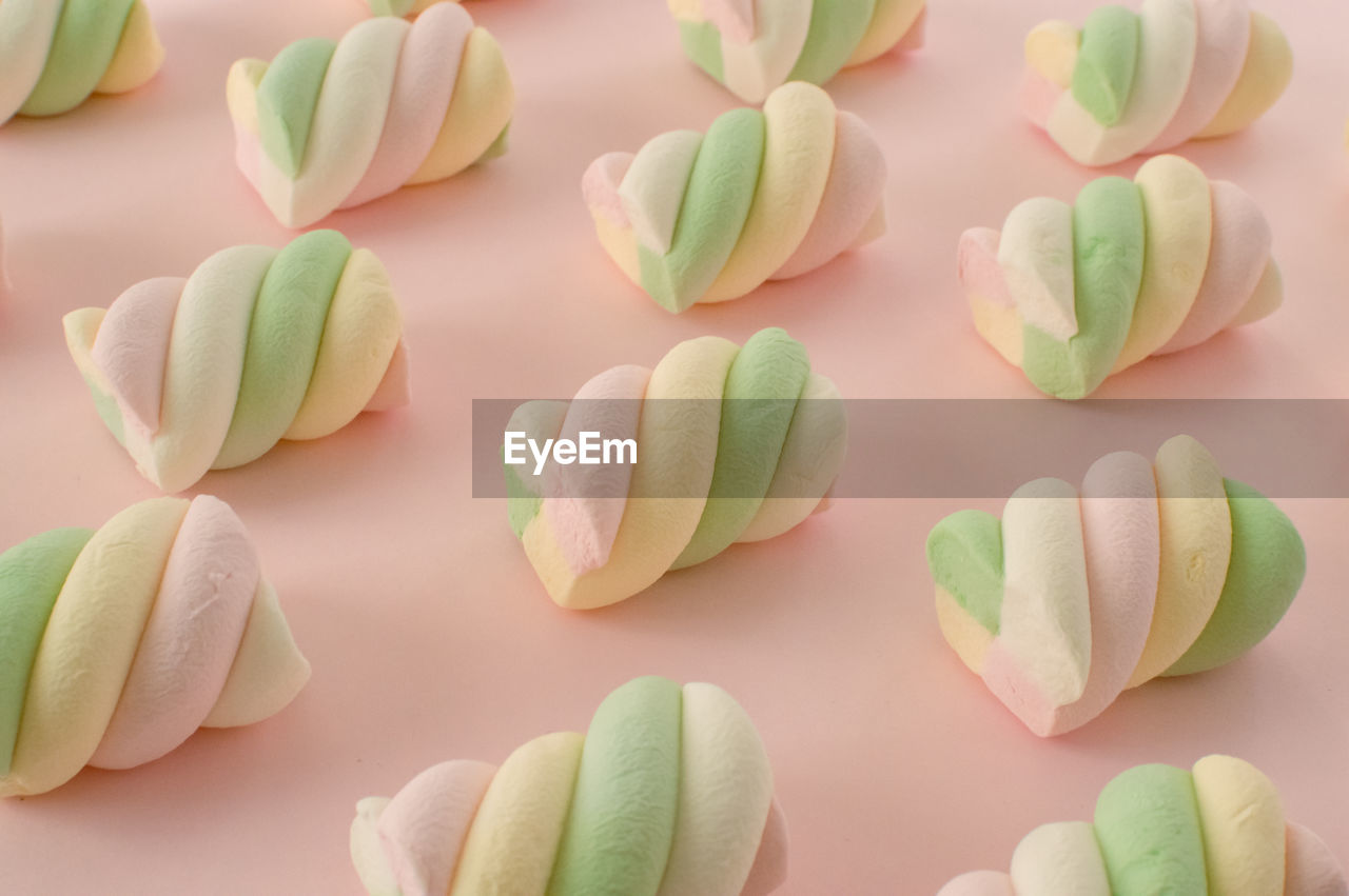 petal, icing, food, food and drink, dessert, pink, sugar paste, flower, cake decorating, no people, sweet food, green, freshness, sweet, indoors, large group of objects, cake, still life, plant, pastel colored, fondant, studio shot, nature, candy