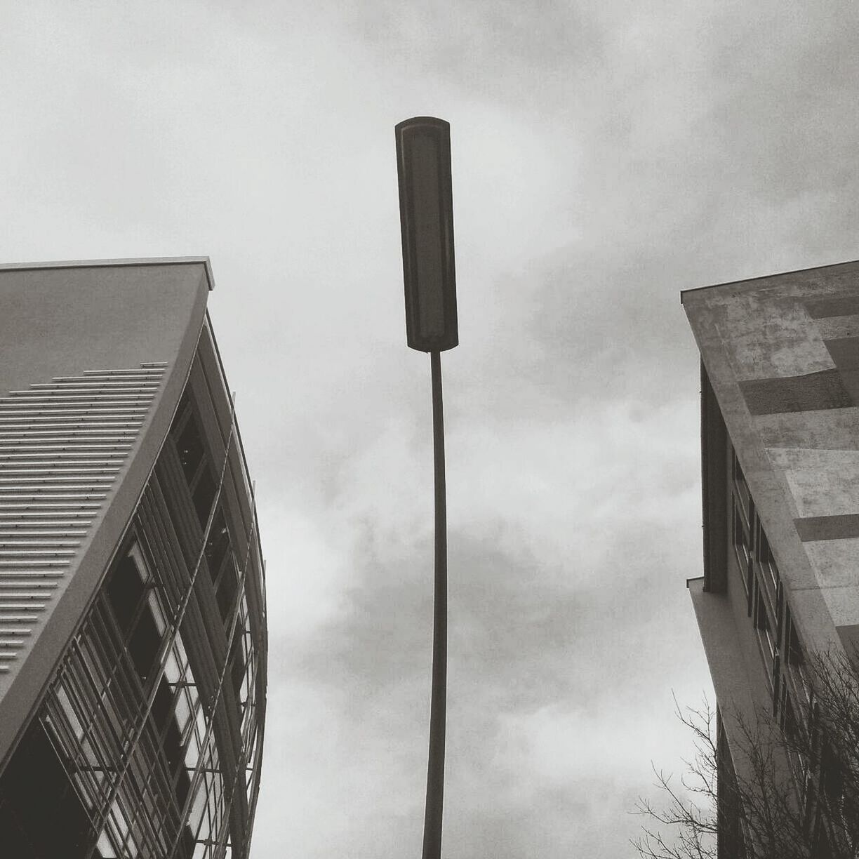 Low angle view of street light and buildings against sky