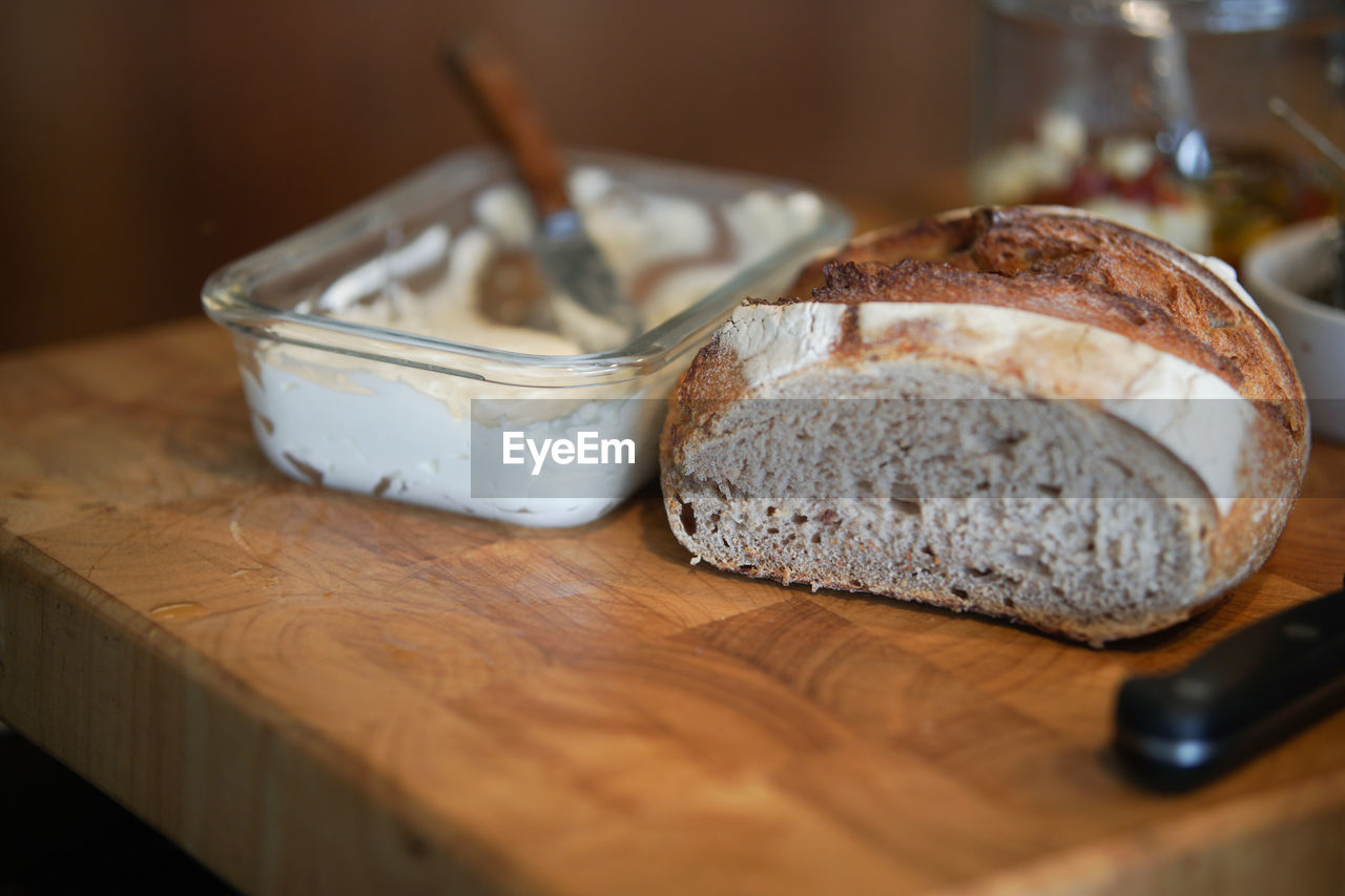 Bread and cream cheese in glass container for breakfast