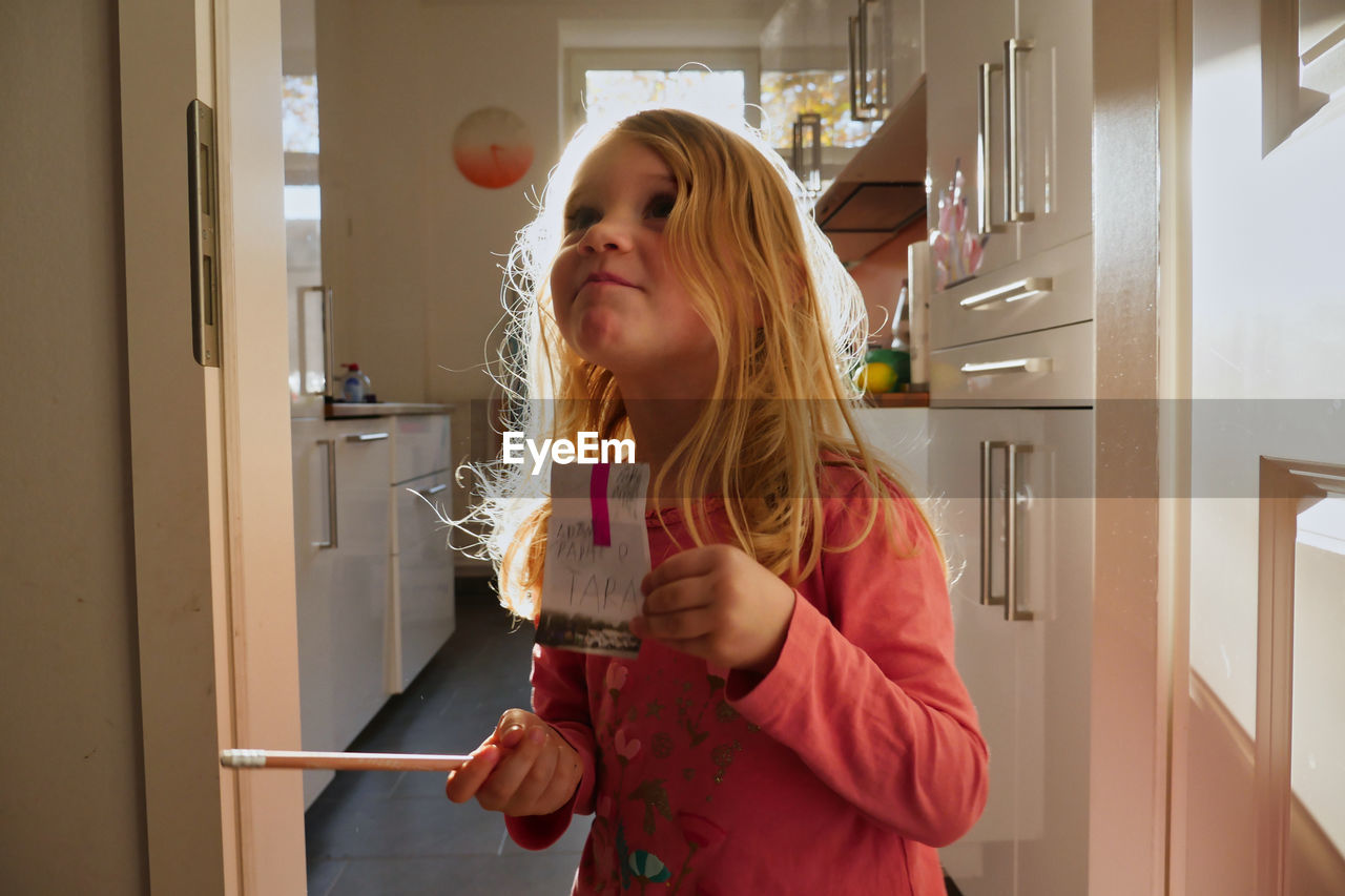 Girl holding ice cream at home