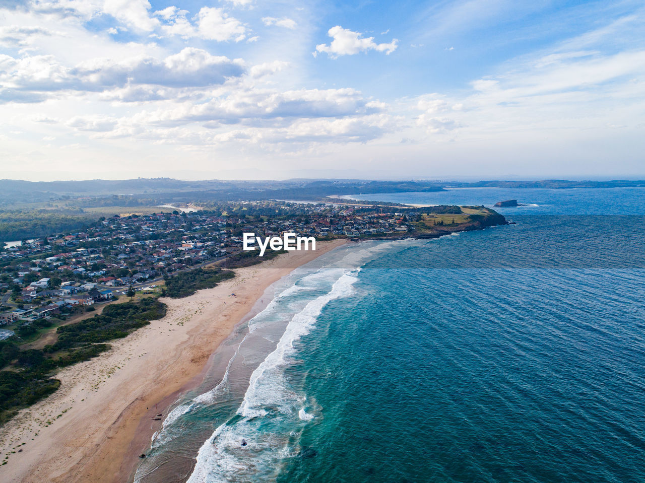 High angle view of sea and buildings against sky