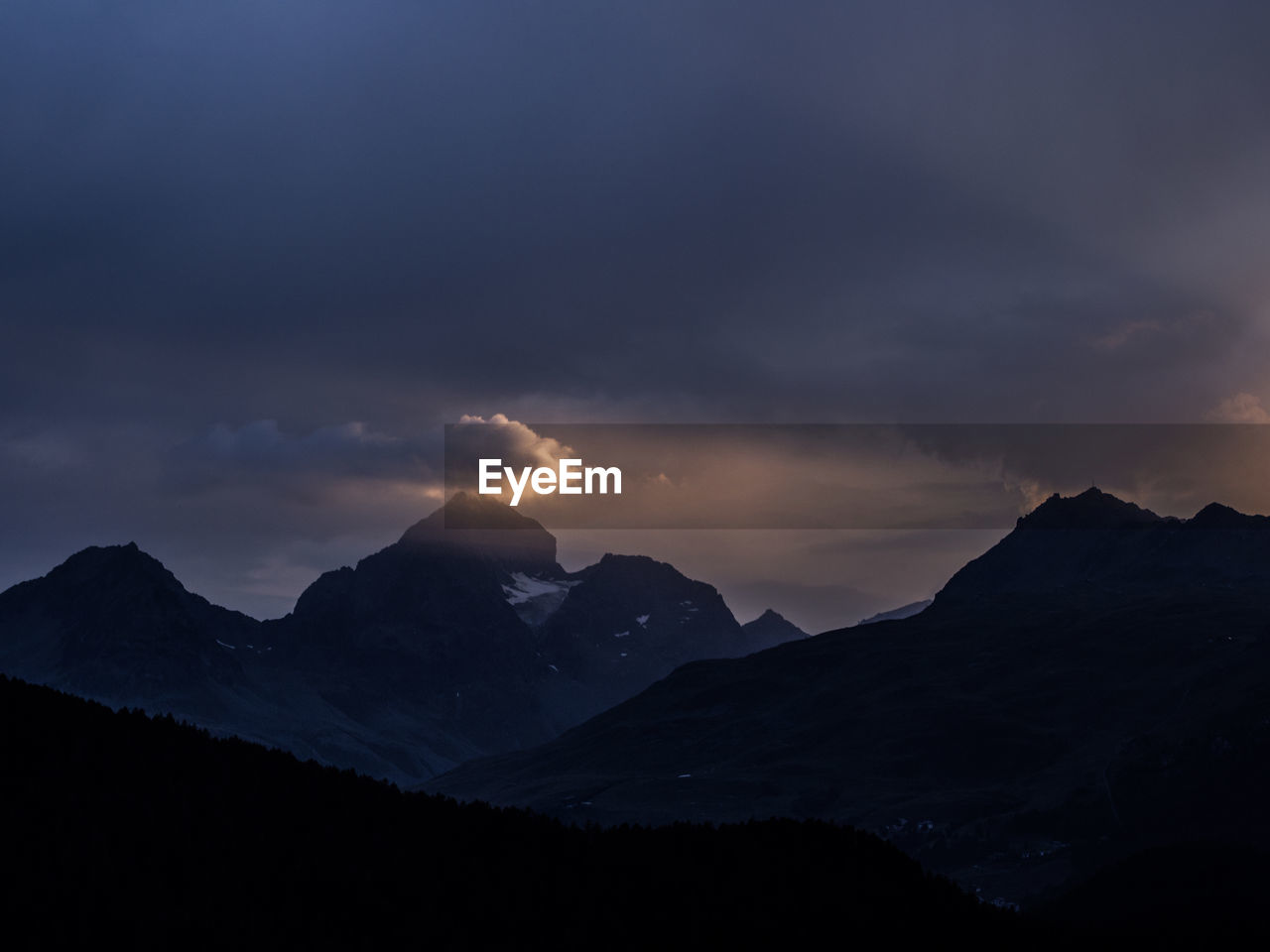 Scenic view of silhouette mountains against sky during sunset