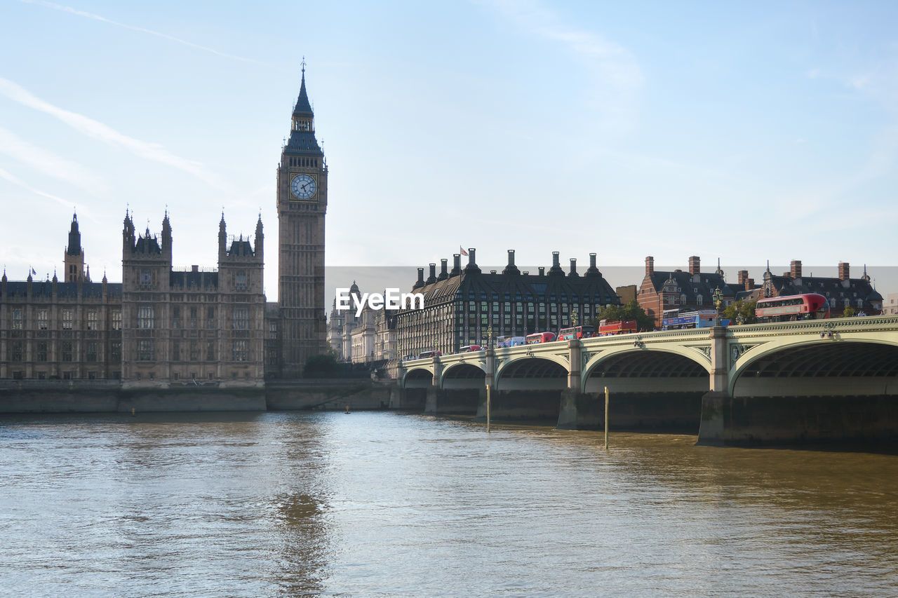 Big ban tower by river in city against sky