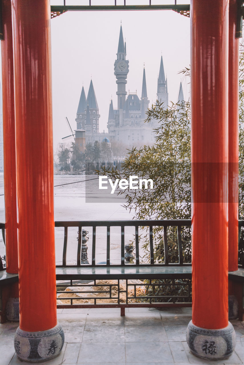 BUILDINGS AGAINST SKY SEEN THROUGH TEMPLE