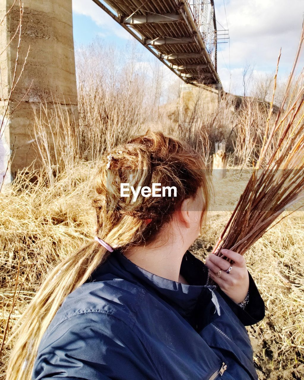 Close-up of woman with stick standing on land