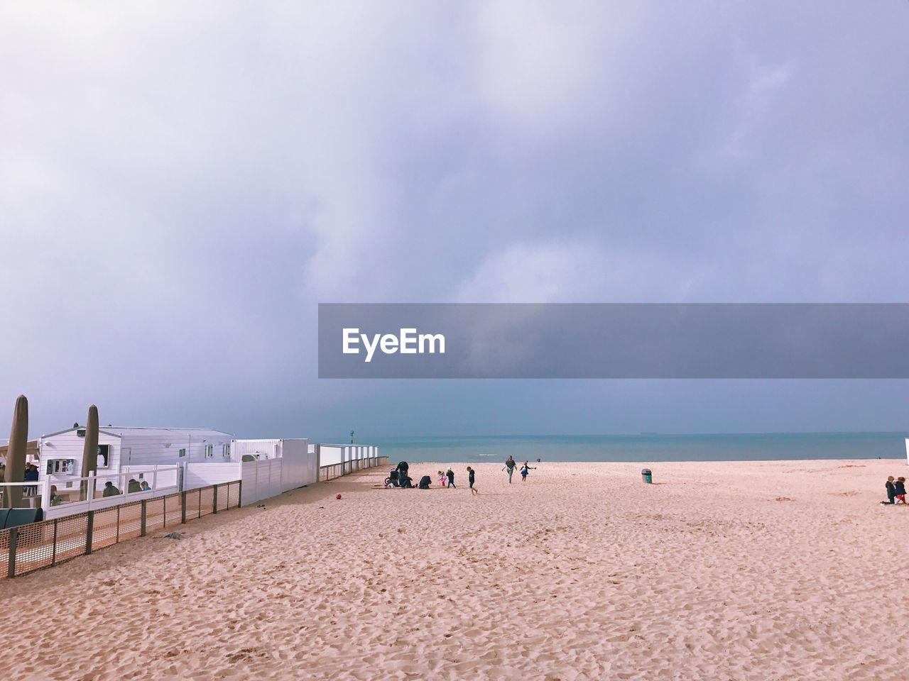 Scenic view of beach against cloudy sky