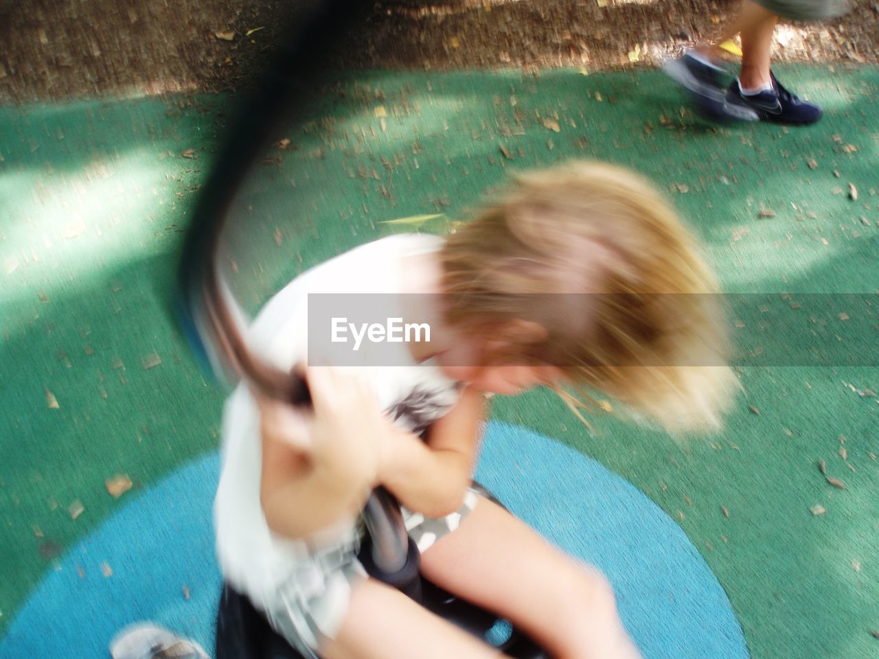 Blurred motion of boy playing in park