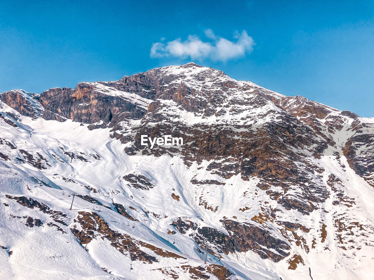 snow, mountain, cold temperature, winter, sky, scenics - nature, environment, mountain range, beauty in nature, landscape, snowcapped mountain, nature, ridge, cloud, piste, blue, travel destinations, no people, travel, tranquility, mountain peak, tranquil scene, day, ski mountaineering, outdoors, summit, non-urban scene, extreme terrain, white, tourism, clear sky, sports, land