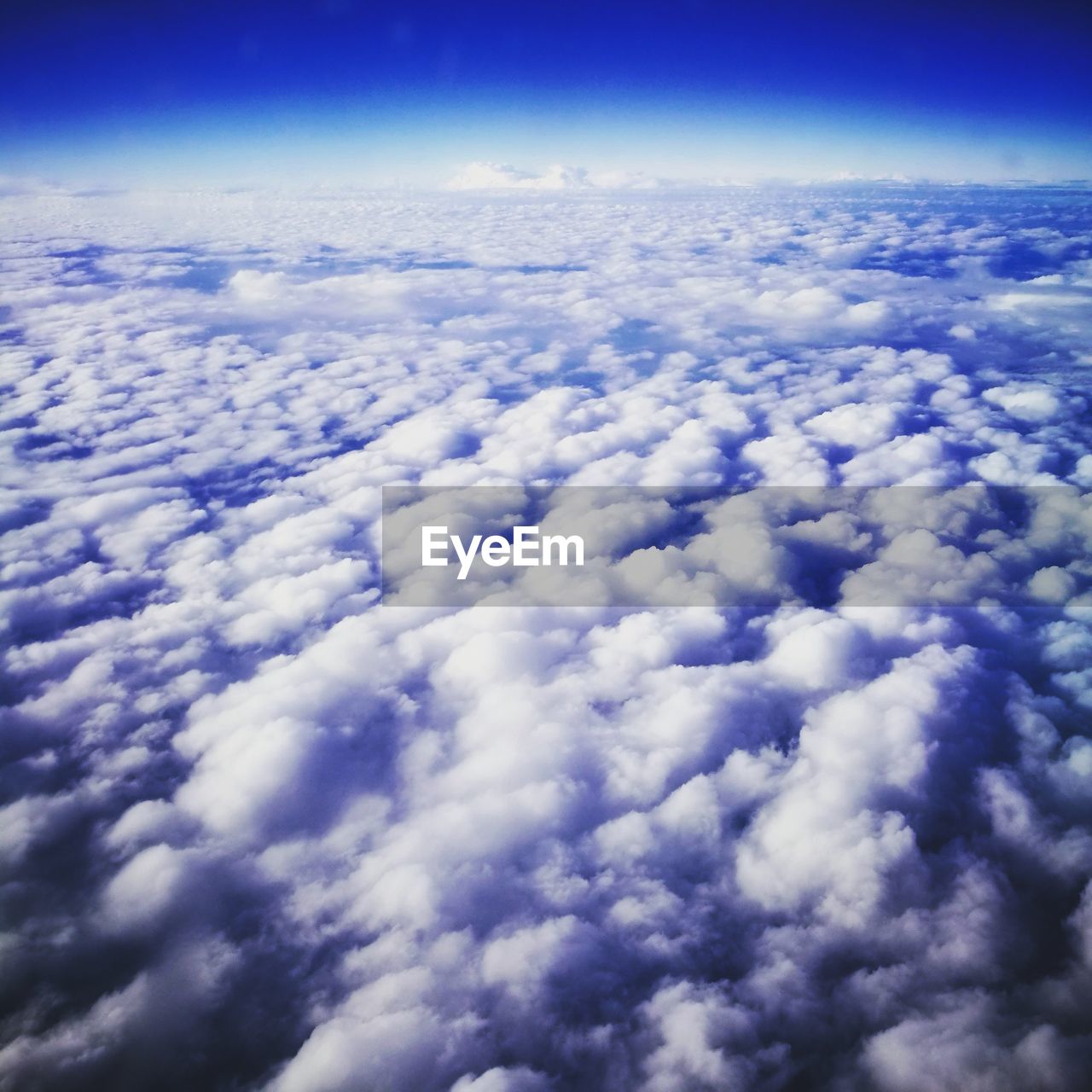 AERIAL VIEW OF CLOUDSCAPE OVER AIRPLANE