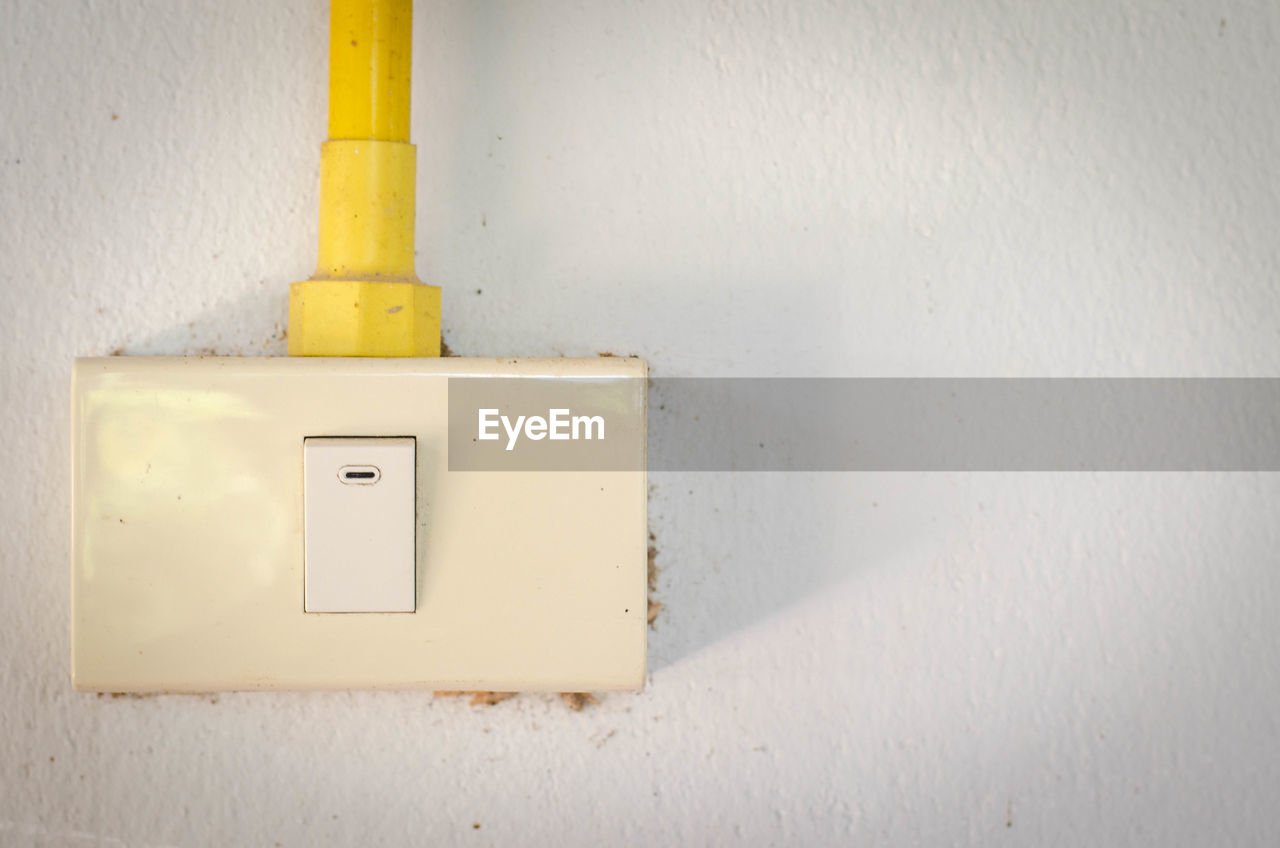 CLOSE-UP OF ELECTRIC LIGHT ON WALL