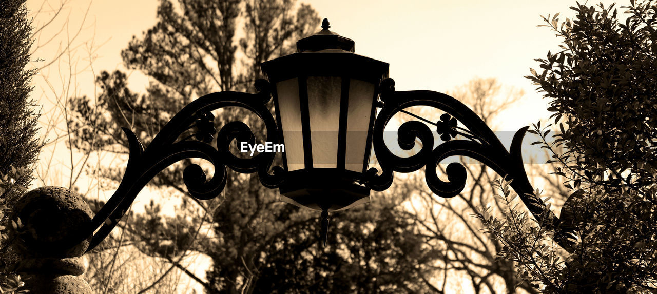 Low angle view of street lights against sky