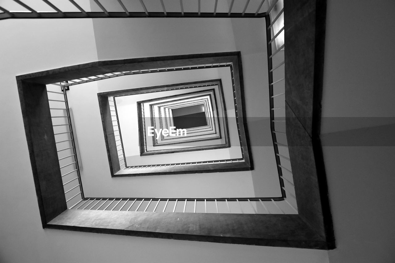 staircase, steps and staircases, spiral, spiral staircase, black, architecture, railing, white, indoors, built structure, monochrome, black and white, no people, pattern, monochrome photography, low angle view, shape, light, picture frame, geometric shape, directly below, stairs, wall - building feature, diminishing perspective
