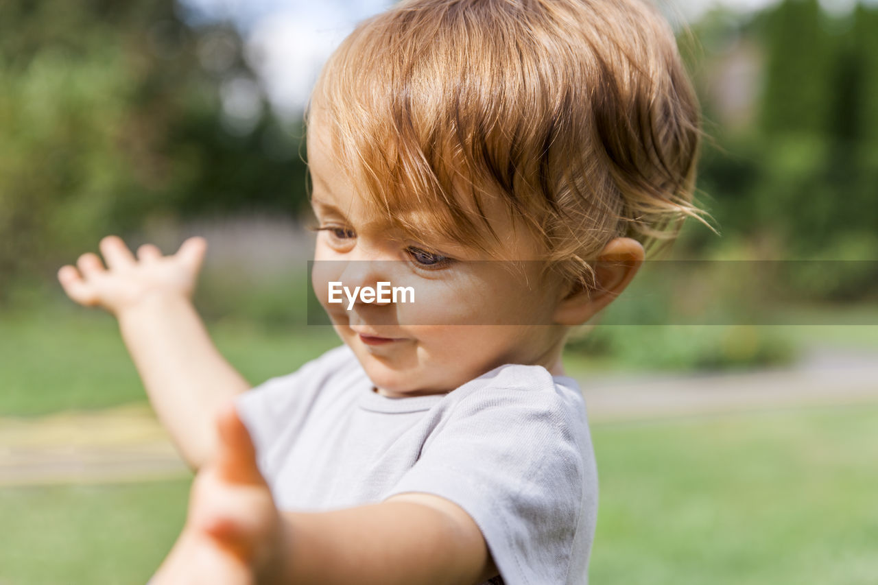 Close-up of innocent boy on field