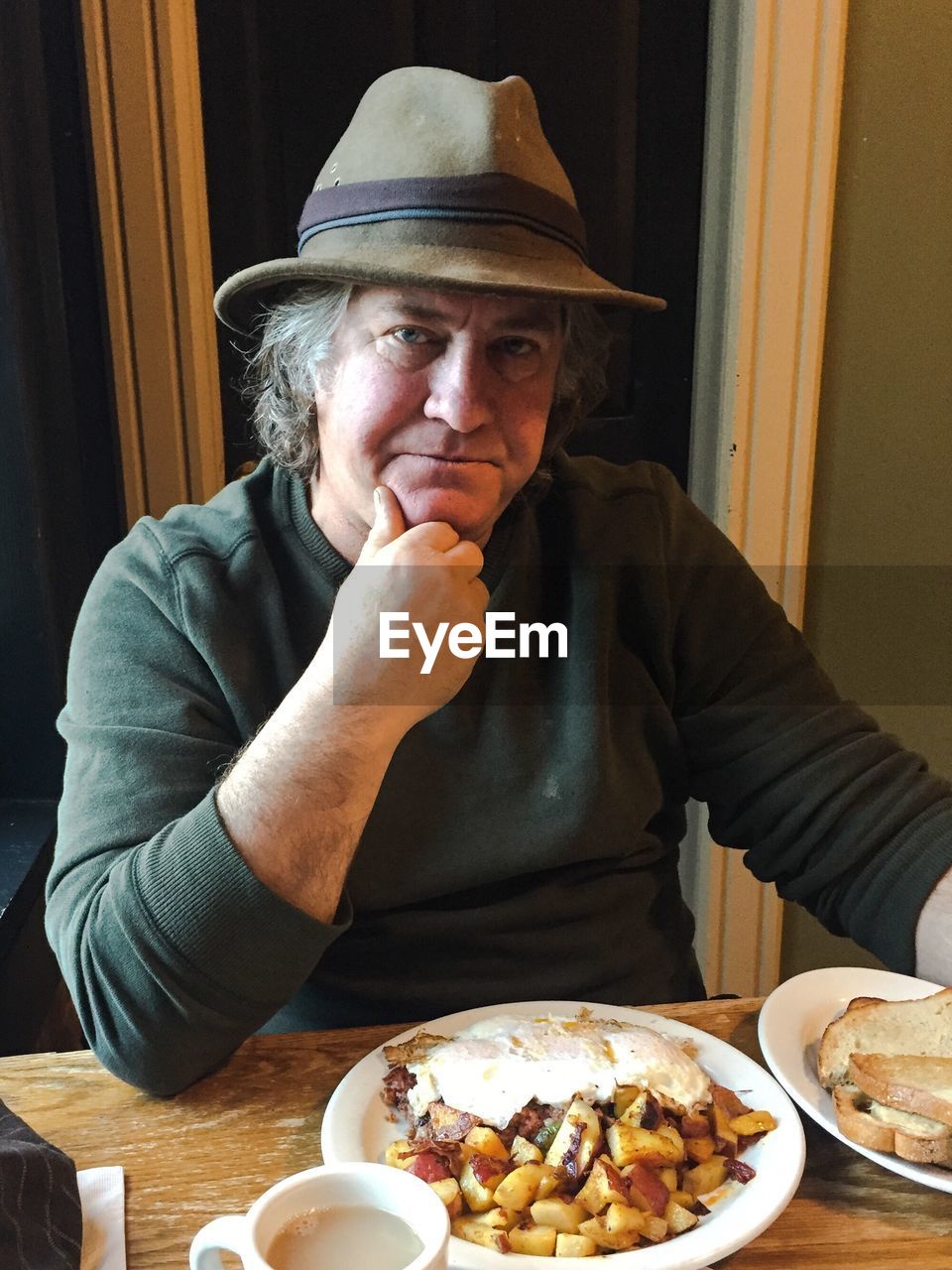 Portrait of man having food at home