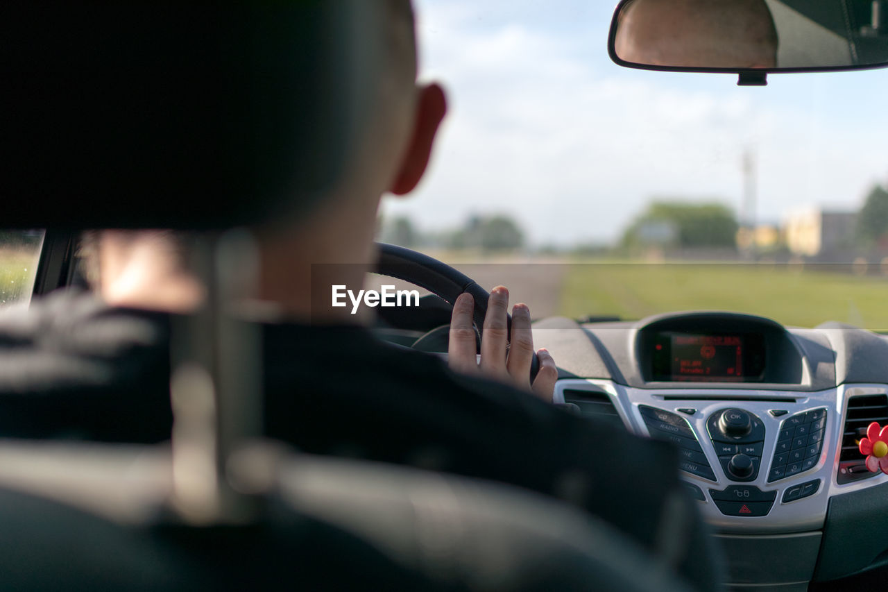 Rear view of man driving car