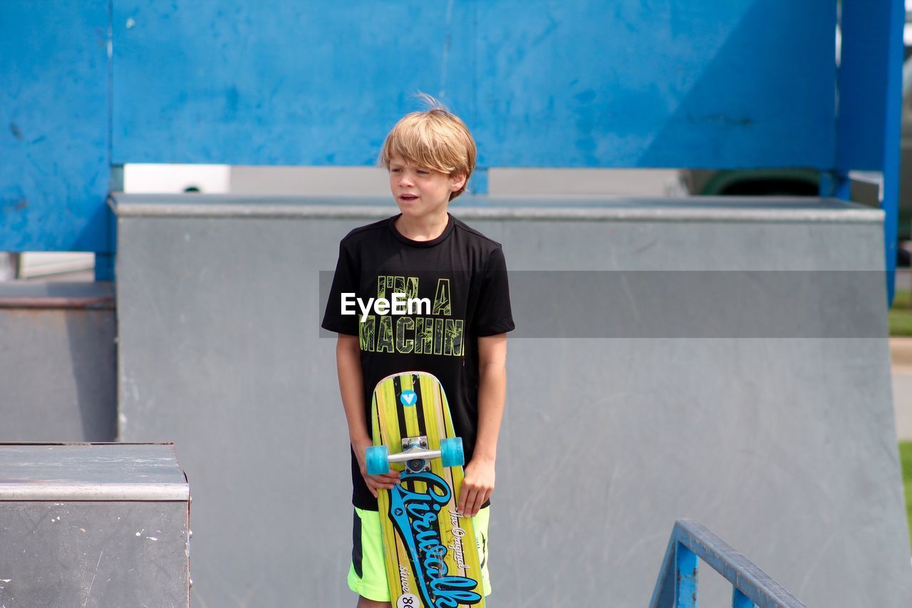 Portrait of cute boy standing outdoors