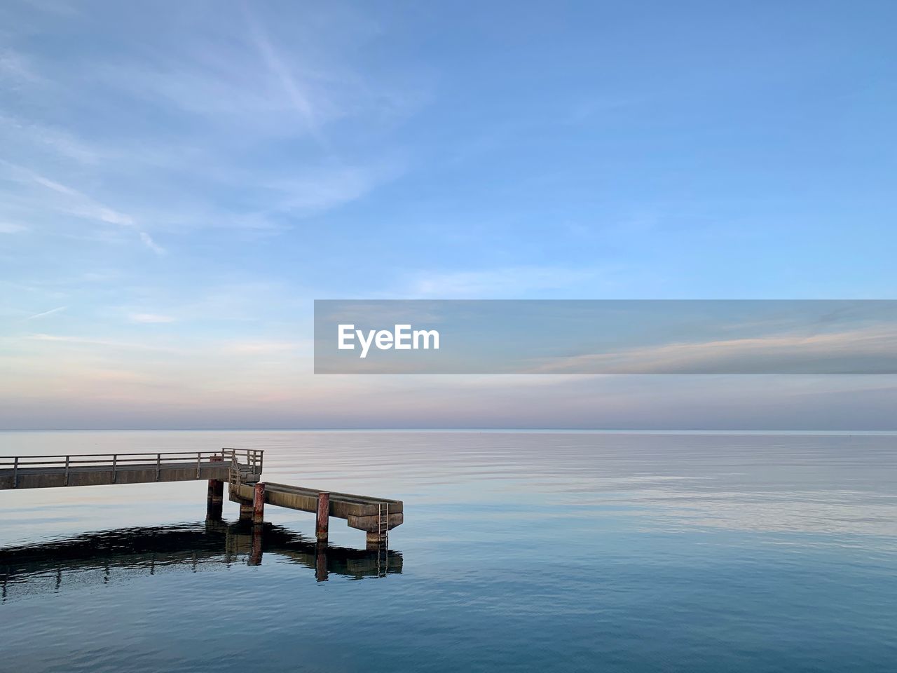 Scenic view of swimming pool by sea against sky