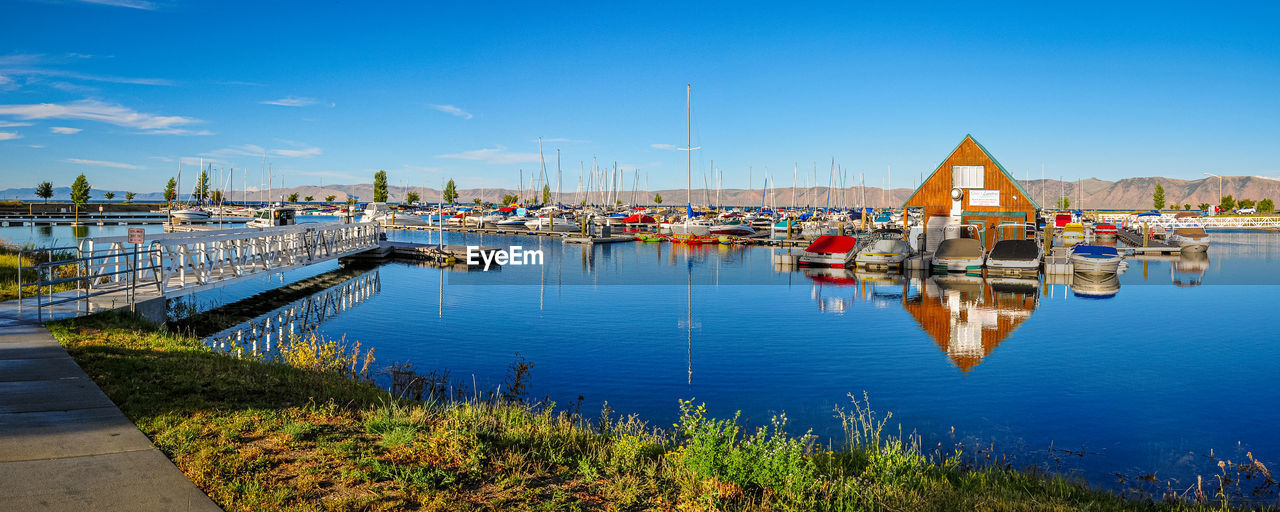 water, nautical vessel, transportation, sky, reflection, nature, architecture, dock, harbor, marina, sea, mode of transportation, blue, travel destinations, travel, city, built structure, no people, ship, moored, vehicle, building exterior, clear sky, bay, landscape, dusk, beauty in nature, outdoors, sailboat, pier, tranquility, coast, scenics - nature, boat, cityscape, day, shore, building, tourism, environment, land, evening, waterway