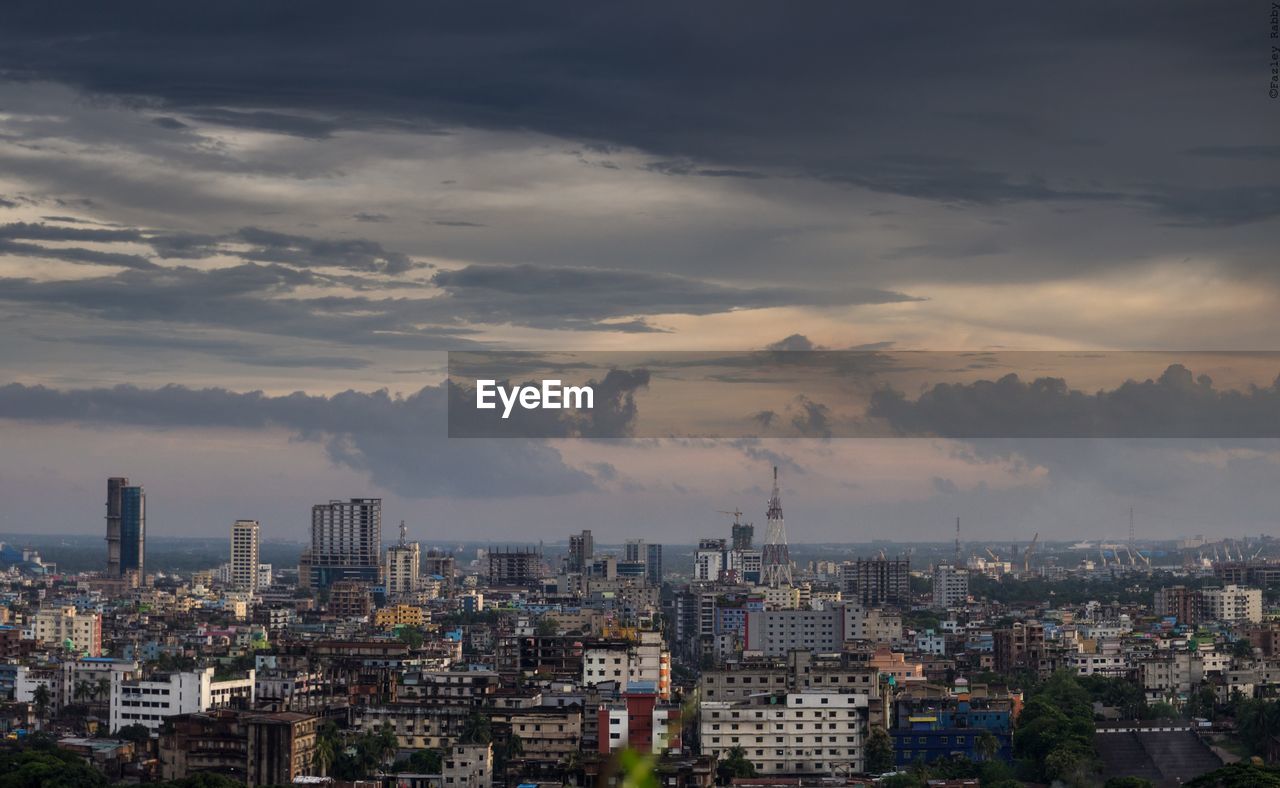 High angle view of cityscape against cloudy sky during sunset