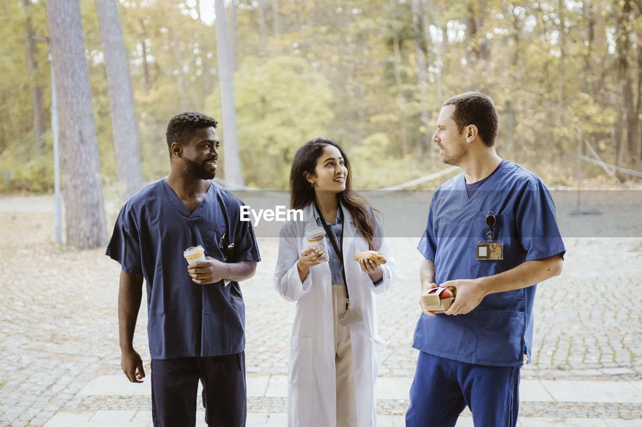 Smiling multiracial healthcare workers talking during break