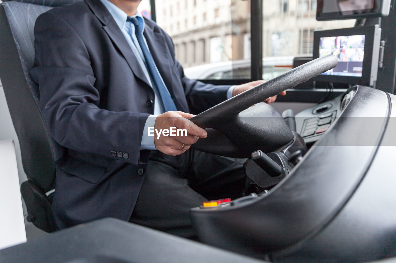 Midsection of man driving bus