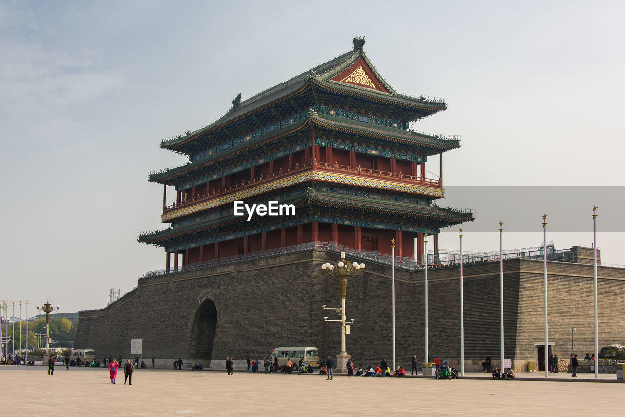 GROUP OF PEOPLE IN TEMPLE AGAINST BUILDING