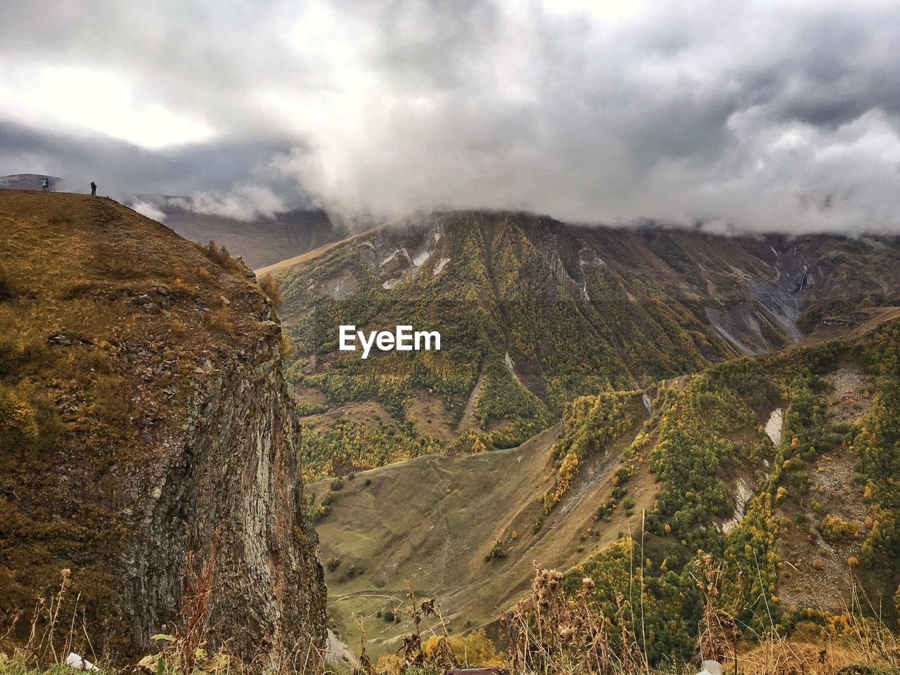 Scenic view of mountains against cloudy sky