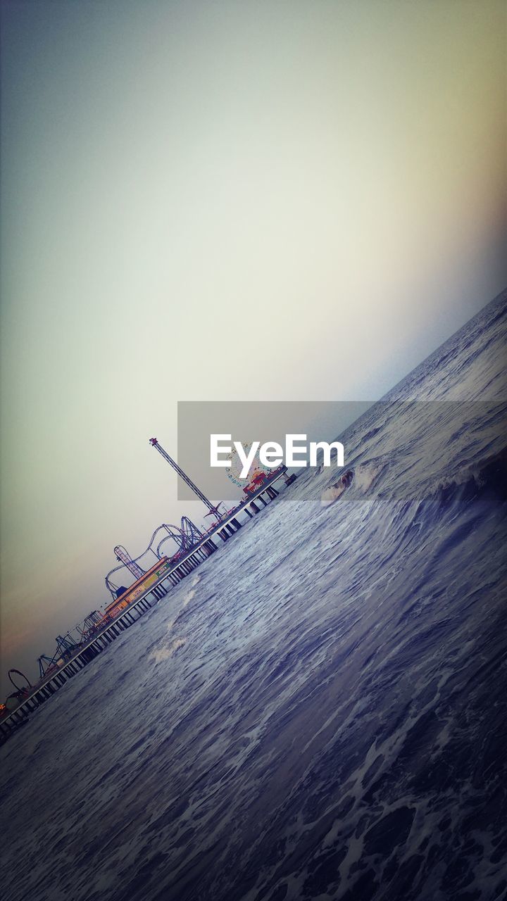 Pleasure pier by sea against sky