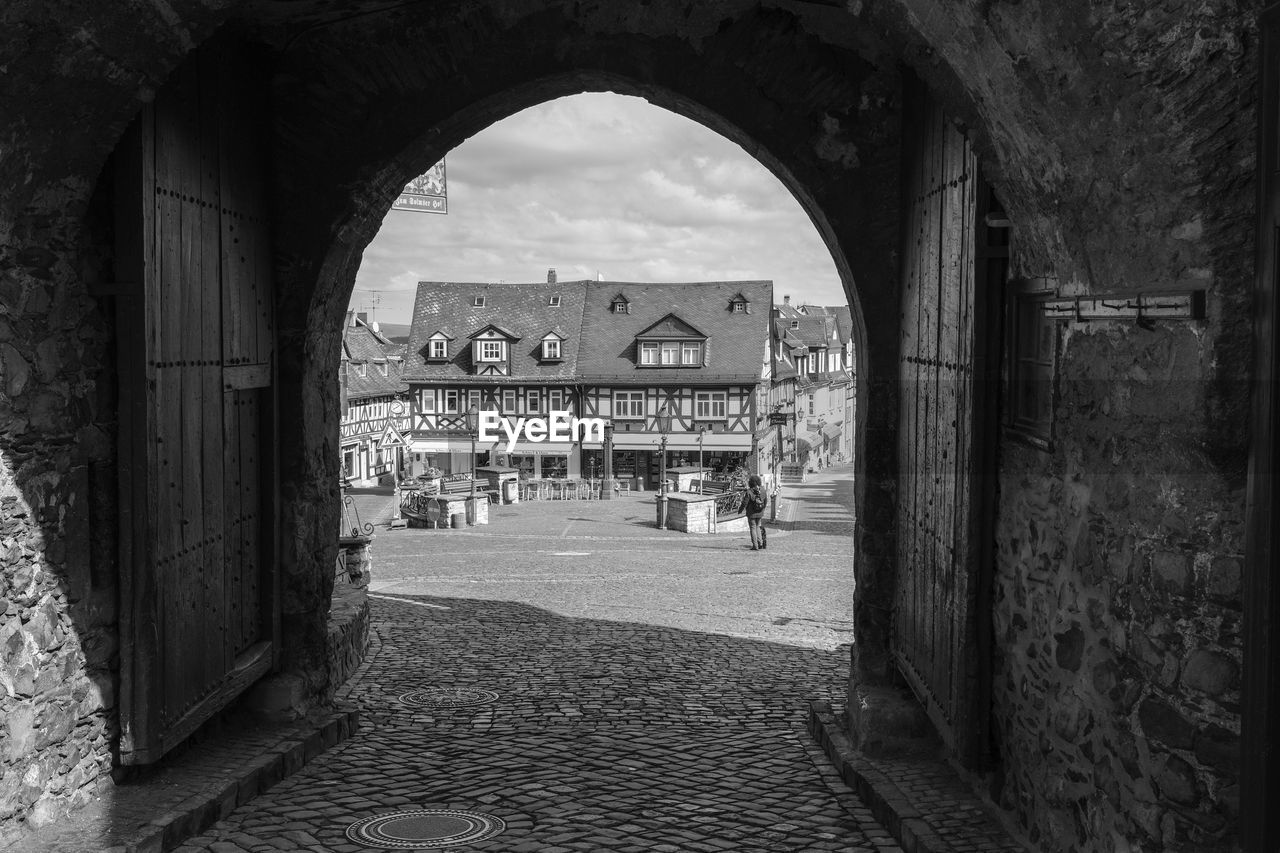 Archway in city against sky