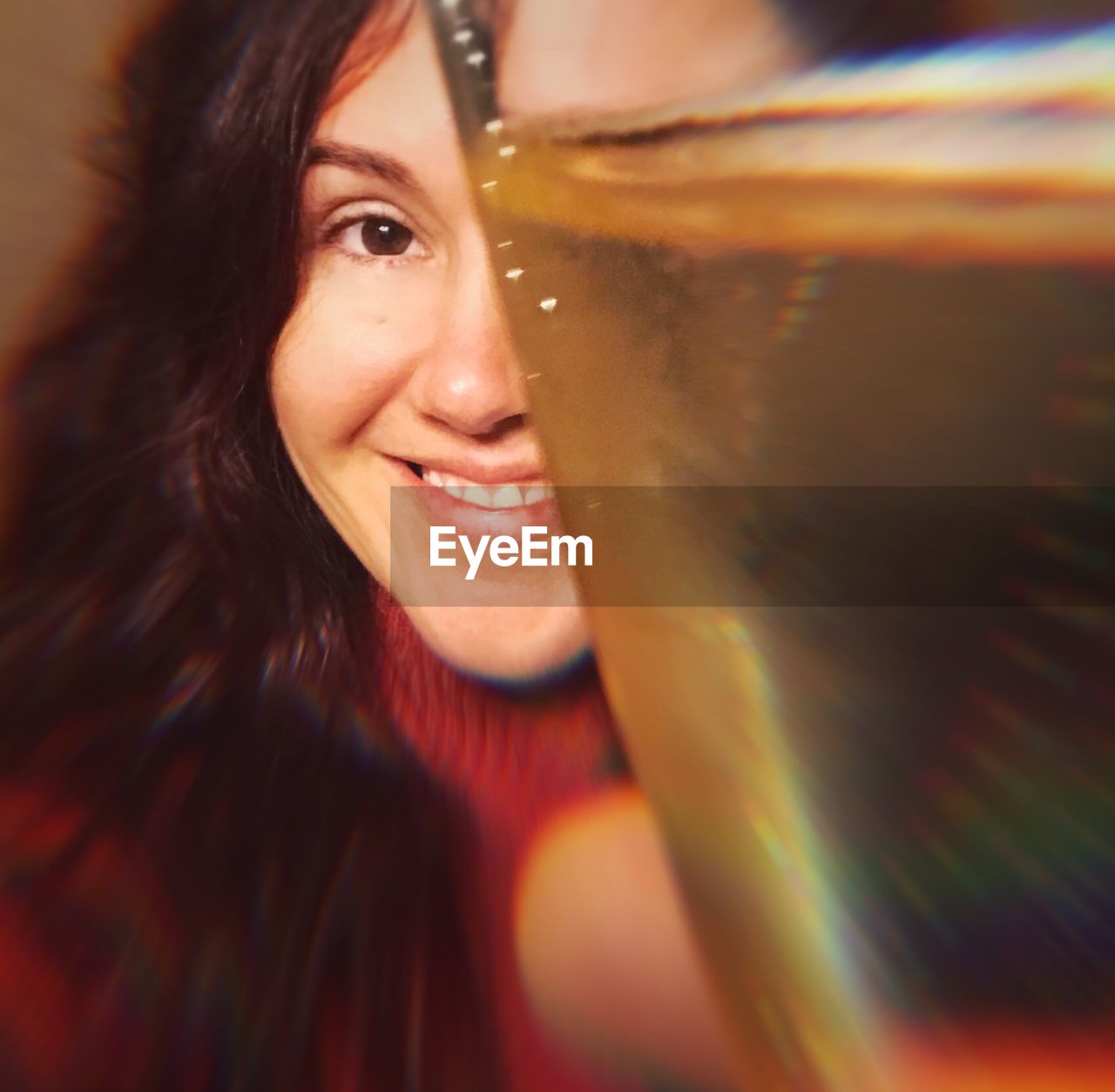 Close-up portrait of smiling woman with drink