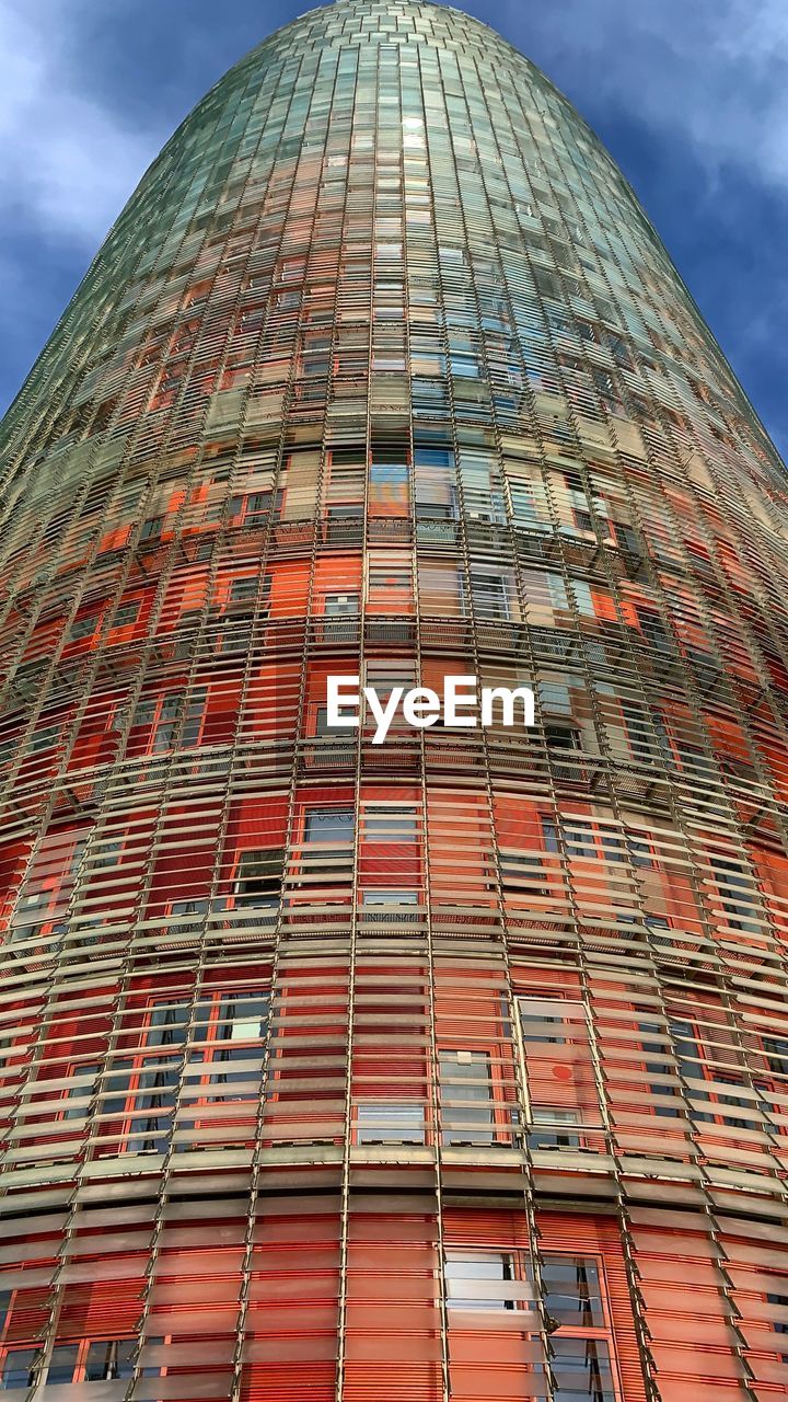 Low angle view of building against cloudy sky