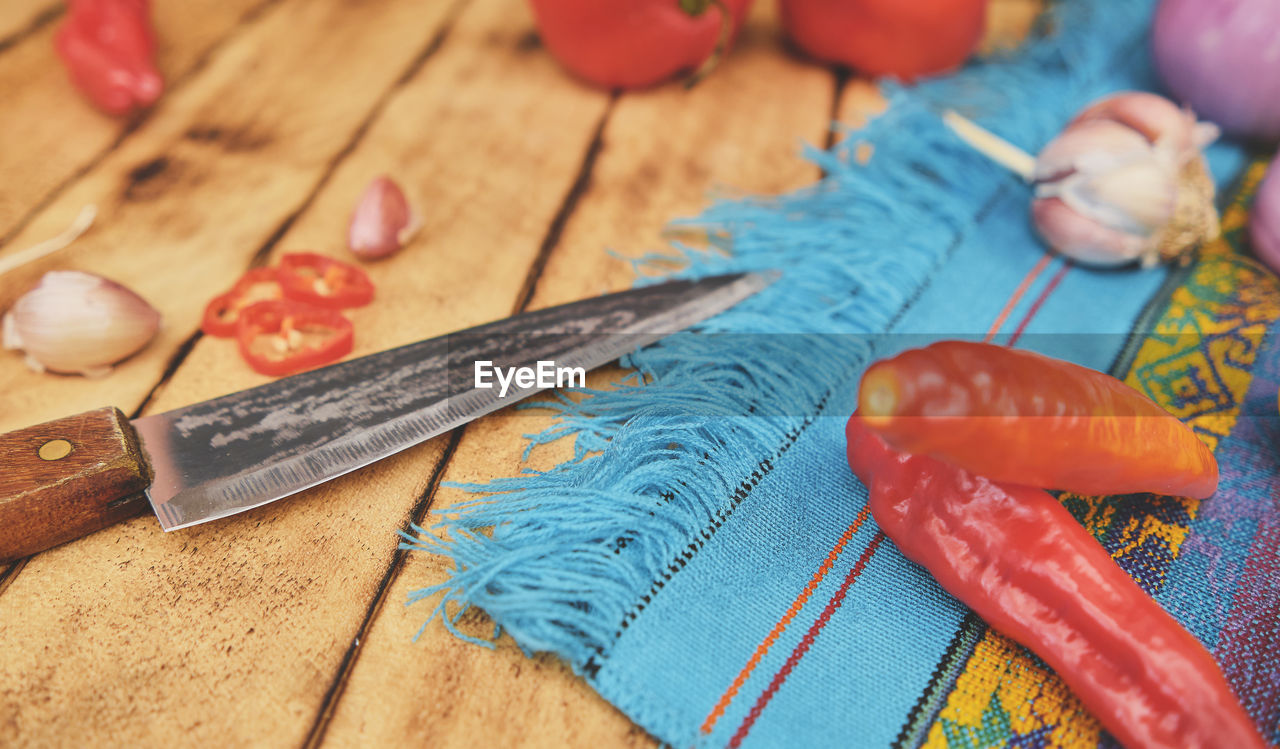 Peruvian ingredients vegetables with cutting board, rocoto chili which has been 