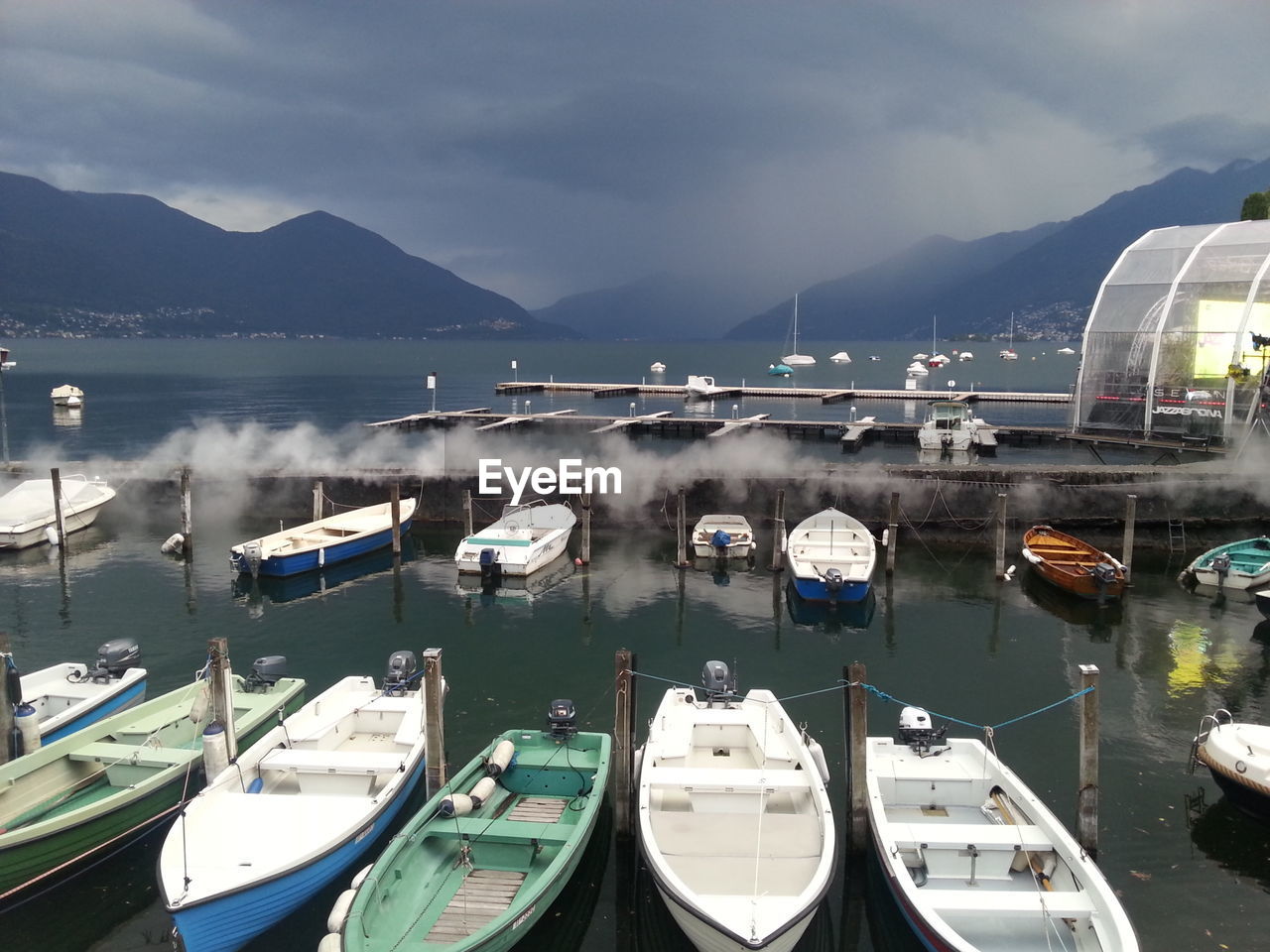 Boats moored in sea against sky