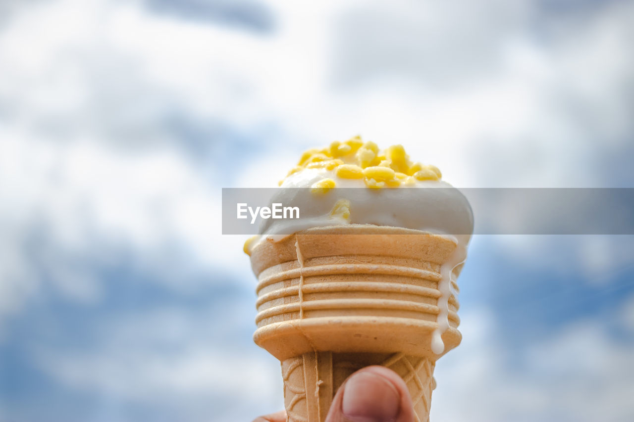 Close-up of hand holding ice cream against blurred background